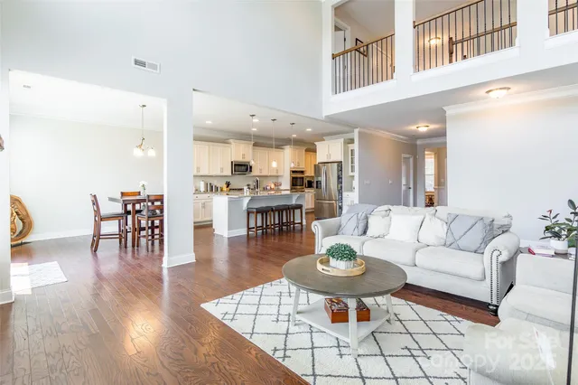 a living room with furniture kitchen view and a table