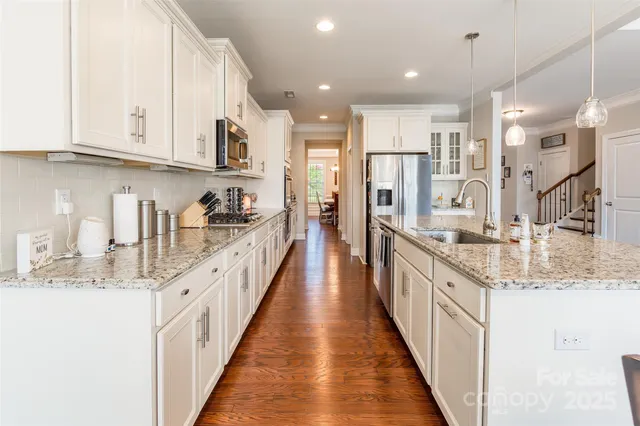 a kitchen with stainless steel appliances granite countertop a sink and cabinets