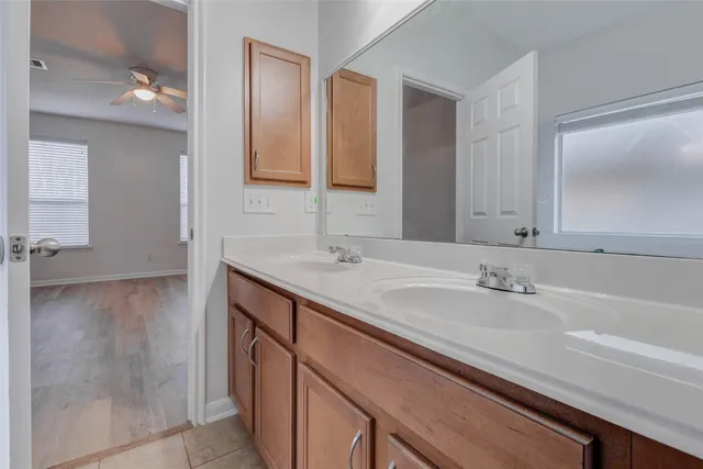 a bathroom with a sink double vanity and a mirror