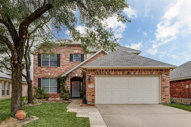 a view of a house with a yard and potted plants