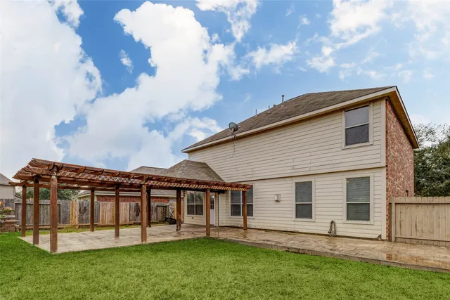 a view of a house with a yard and sitting area