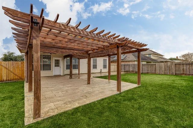 a view of a house with a backyard and a patio