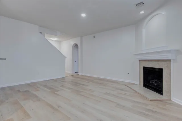 a view of an empty room with a fireplace