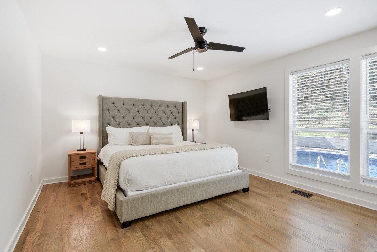 270 Hurt Road Hendersonville, TN 37075 - Photo 32 of 68 a bedroom with a bed a flat screen tv and a large window