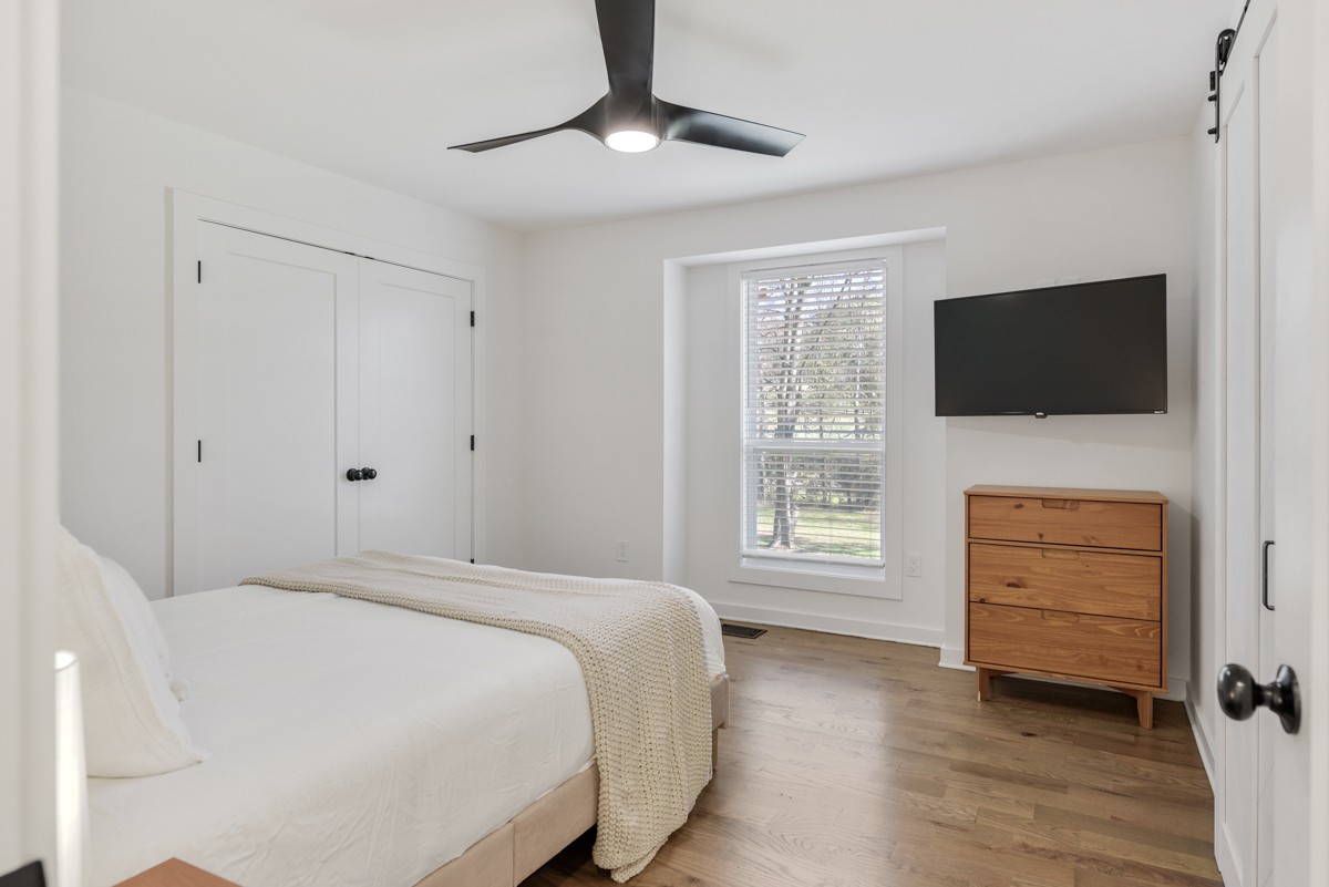 270 Hurt Road Hendersonville, TN 37075 - Photo 41 of 68 a bedroom with a bed a flat screen tv and a chandelier