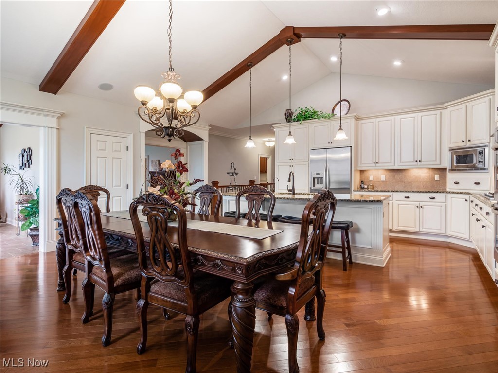 5349 Slater Ridge Westerville, OH 43082 - Photo 14 of 50 Dining area featuring beamed ceiling, dark wood-style flooring, a chandelier, and high vaulted ceiling