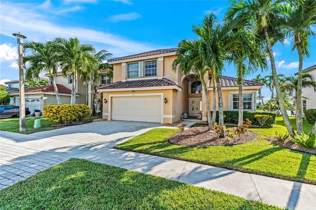 a front view of a house with garden and patio