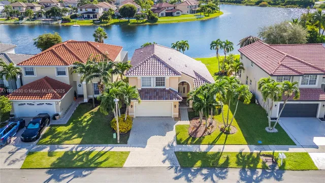 an aerial view of residential houses with outdoor space and swimming pool