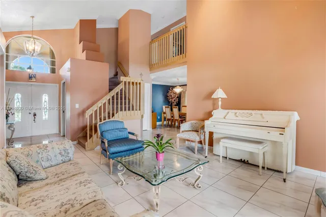 a living room with furniture and a floor to ceiling window
