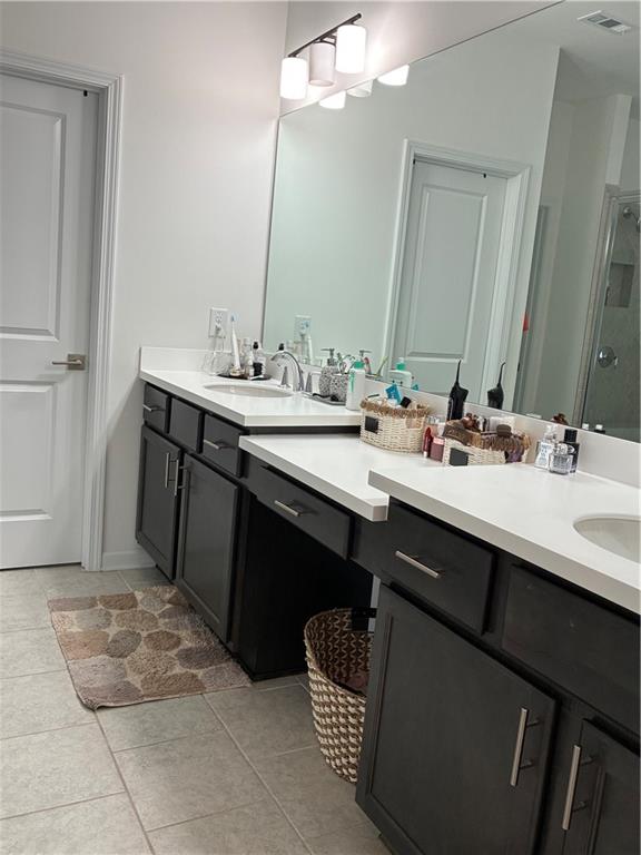 3660 Andover Street Cumming, GA 30028 - Photo 18 of 36 a bathroom with a sink double vanity and a mirror