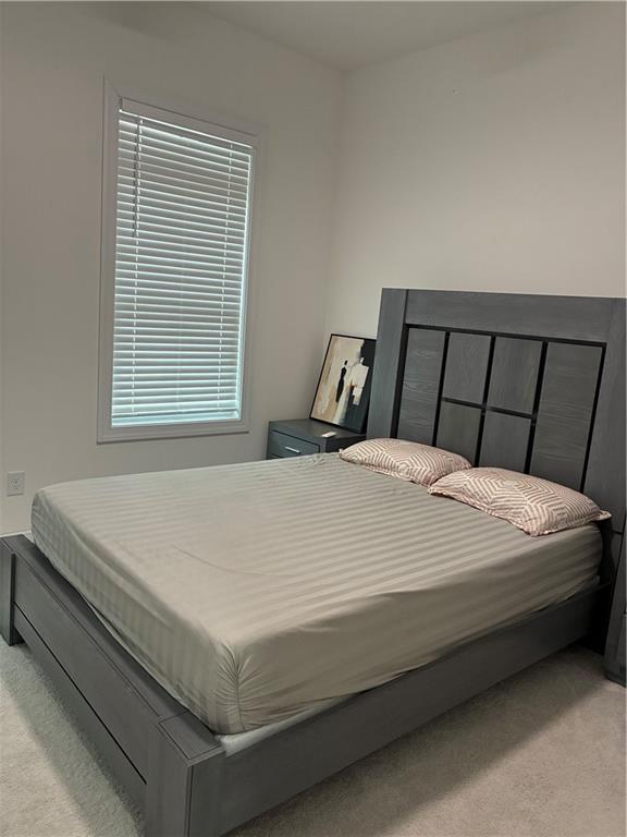 3660 Andover Street Cumming, GA 30028 - Photo 20 of 36 a bed sitting in a bedroom next to a window