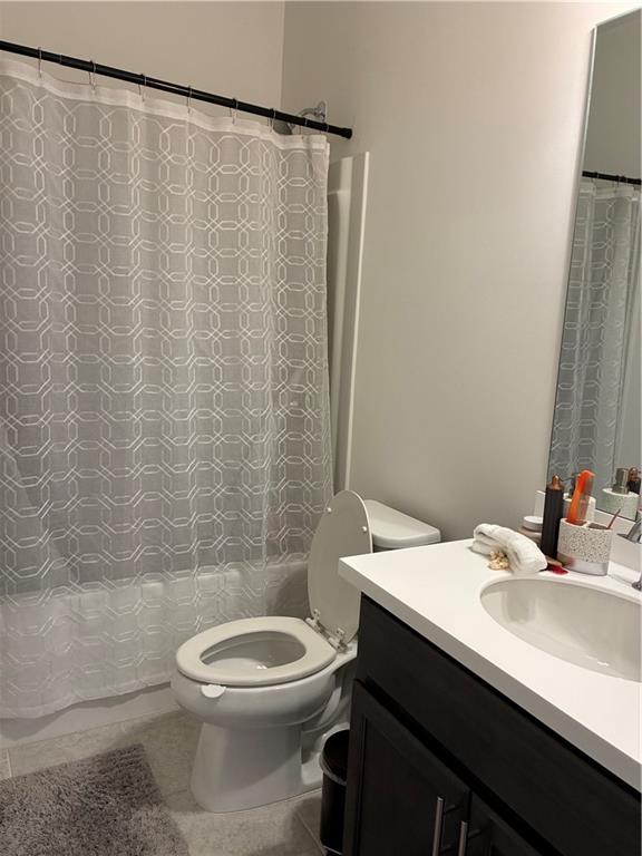 3660 Andover Street Cumming, GA 30028 - Photo 21 of 36 a bathroom with a sink a toilet and shower curtain