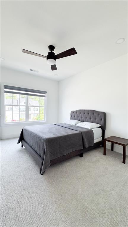 3660 Andover Street Cumming, GA 30028 - Photo 30 of 36 a spacious bedroom with a bed and a couch