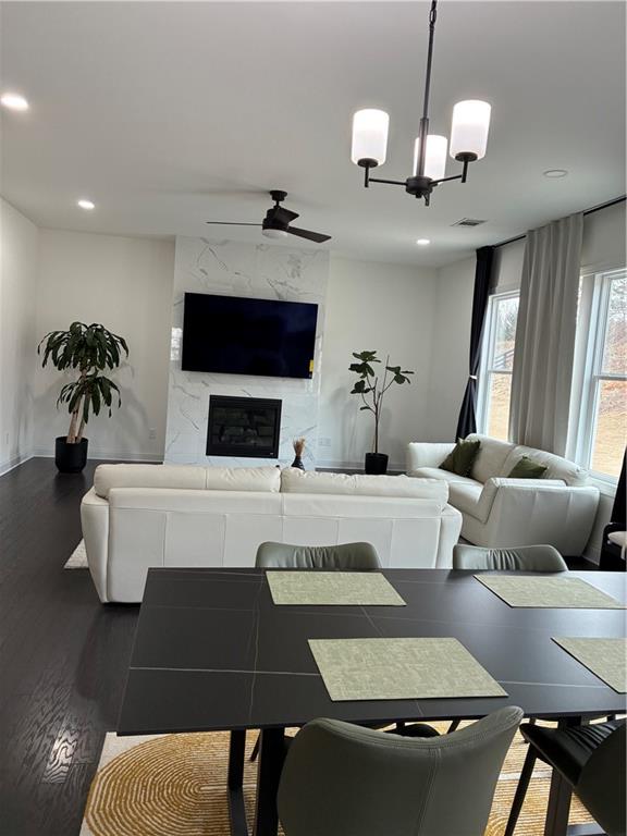 3660 Andover Street Cumming, GA 30028 - Photo 5 of 36 a living room with furniture a chandelier and a flat screen tv