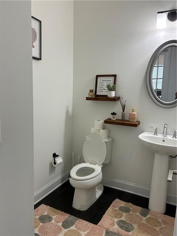 3660 Andover Street Cumming, GA 30028 - Photo 7 of 36 a bathroom with a toilet a sink and a mirror