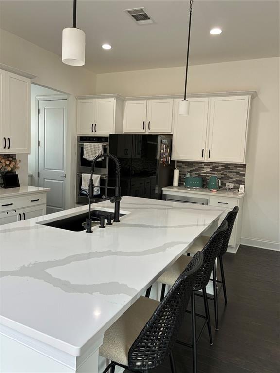 3660 Andover Street Cumming, GA 30028 - Photo 10 of 36 a kitchen with stainless steel appliances kitchen island a sink and a refrigerator