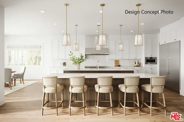 a kitchen with granite countertop a counter space and chairs in it