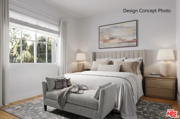 a bedroom with a bed and a painting on the wall