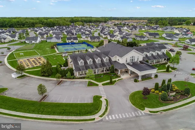 an aerial view of residential houses with outdoor space and lake view