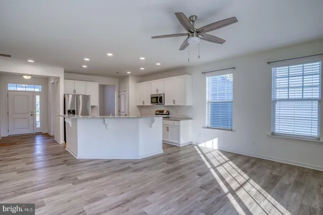 a view of kitchen with cabinets and wooden floor