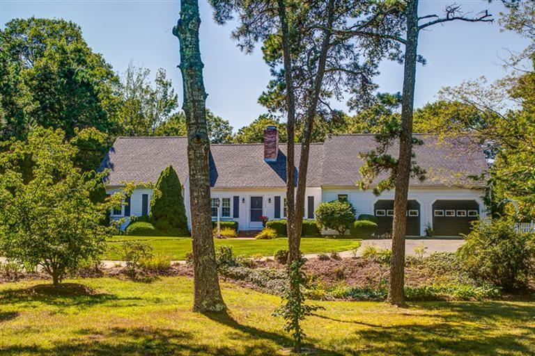 1136 Old Post Road Cotuit, MA 02635 - Photo 1 of 20 a front view of a house with swimming pool and a yard