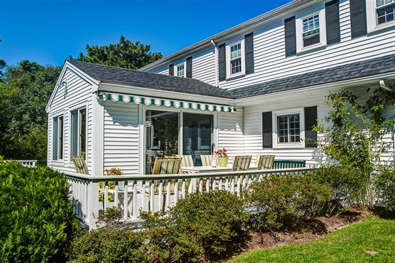 1136 Old Post Road Cotuit, MA 02635 - Photo 17 of 20 a house with lots of trees in the background