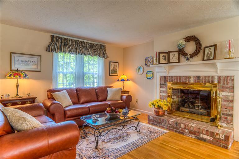 1136 Old Post Road Cotuit, MA 02635 - Photo 7 of 20 a living room with furniture and a fireplace