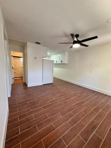 a view of a room with wooden floor