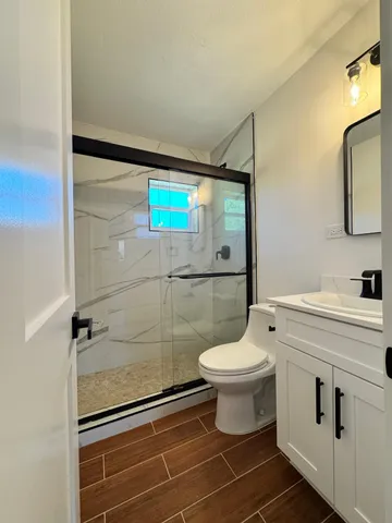 a bathroom with a toilet a sink and shower