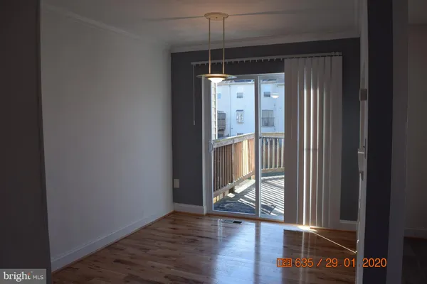 an empty room with wooden floor and a window