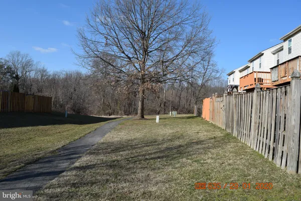 a view of a yard with wooden fence