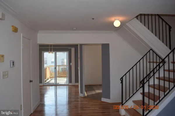 a view of an entryway with wooden floor