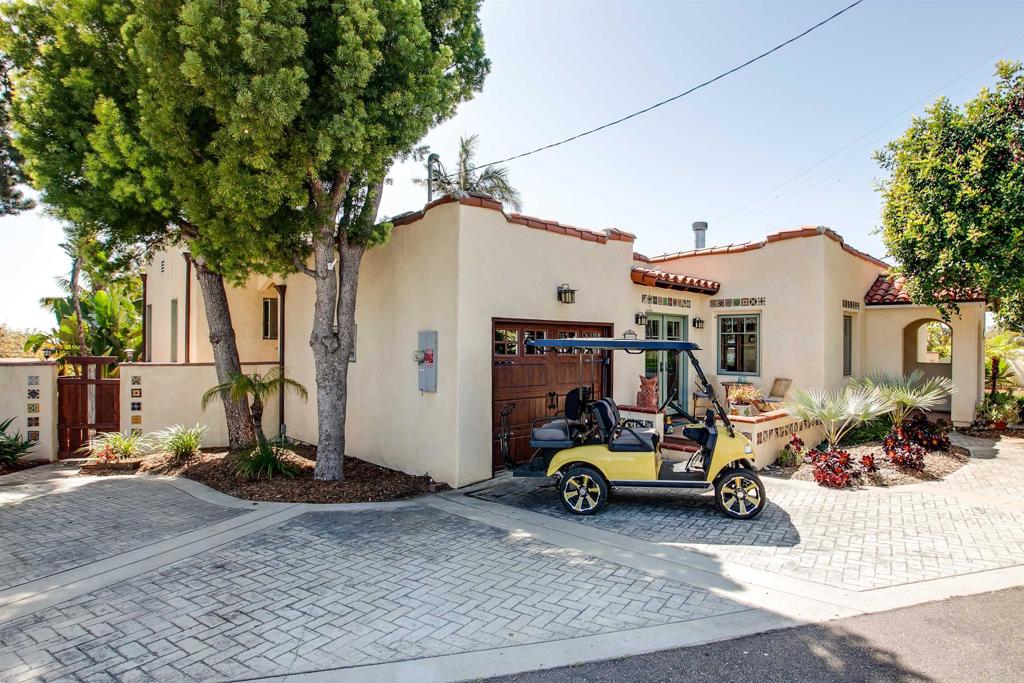 a car parked in front of a white house