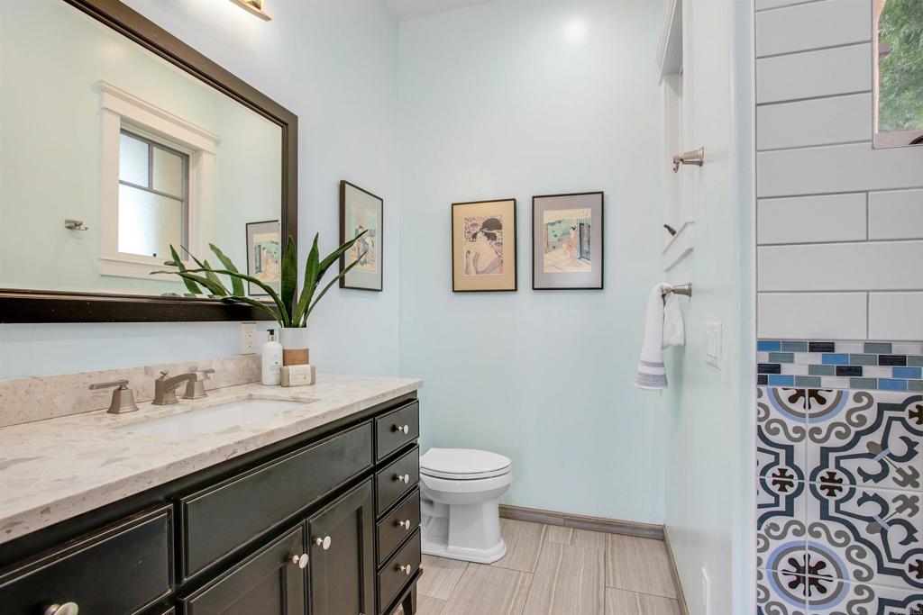 1503 Ridgeway Street Oceanside, CA 92054 - Photo 18 of 56 a bathroom with a granite countertop sink and a mirror