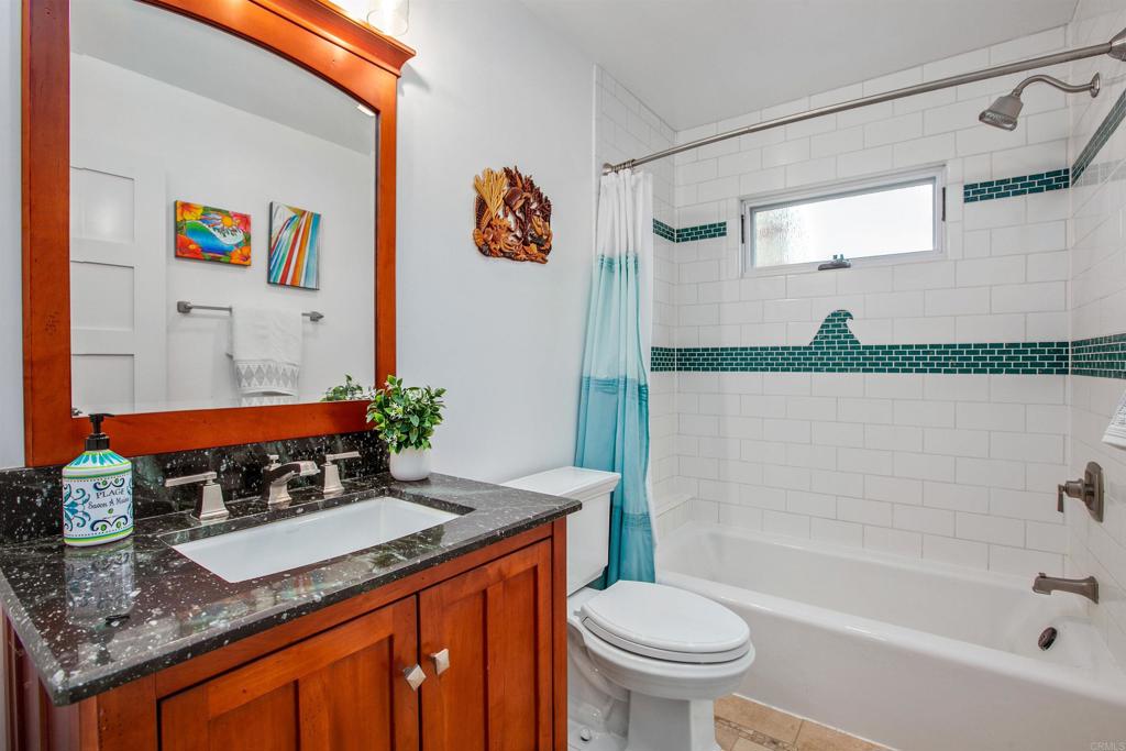1503 Ridgeway Street Oceanside, CA 92054 - Photo 22 of 56 a bathroom with a granite countertop sink a toilet and a bathtub