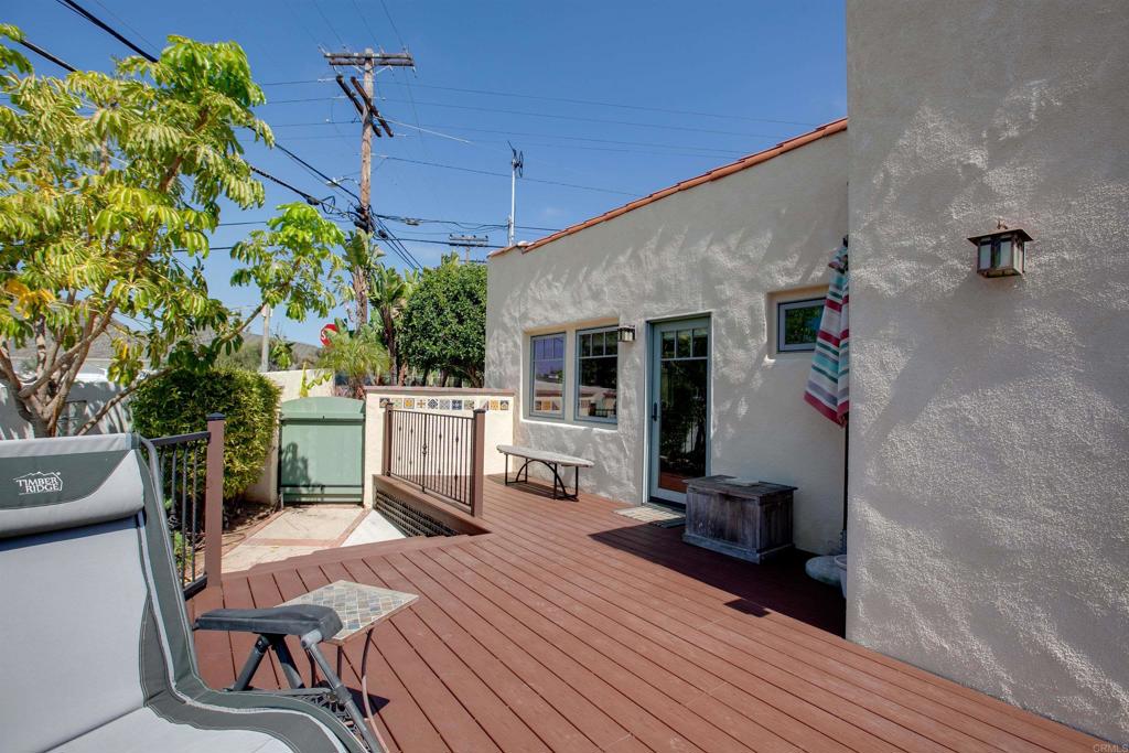 1503 Ridgeway Street Oceanside, CA 92054 - Photo 34 of 56 a view of a deck with table and chairs with wooden floor and fence