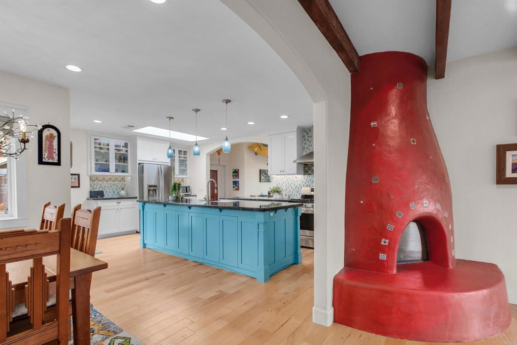 1503 Ridgeway Street Oceanside, CA 92054 - Photo 6 of 56 a kitchen with stainless steel appliances kitchen island granite countertop a stove a sink a dining table and chairs