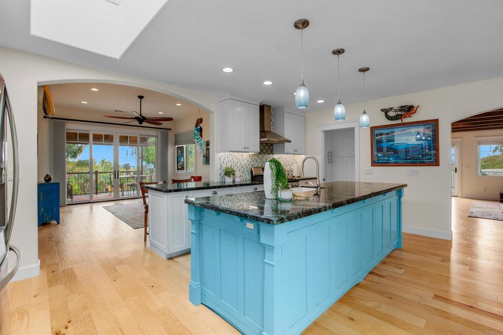 1503 Ridgeway Street Oceanside, CA 92054 - Photo 9 of 56 a kitchen with kitchen island granite countertop a sink and cabinets