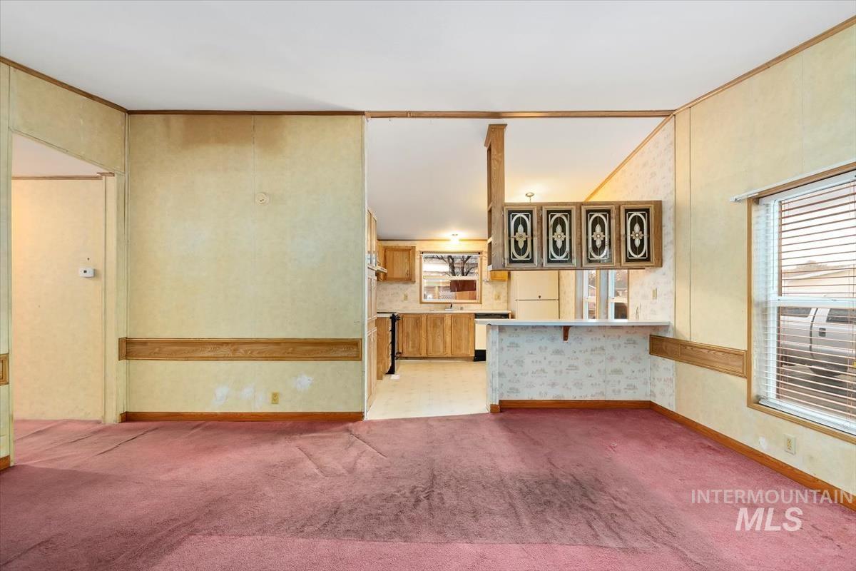 2804 Golden Rod Lane Caldwell, ID 83605 - Photo 18 of 35 Unfurnished living room with crown molding and light carpet