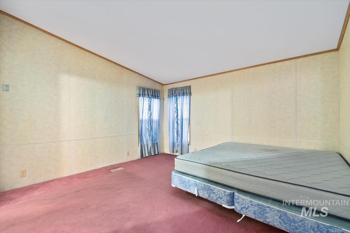 2804 Golden Rod Lane Caldwell, ID 83605 - Photo 5 of 35 Bedroom featuring carpet, ornamental molding, and vaulted ceiling