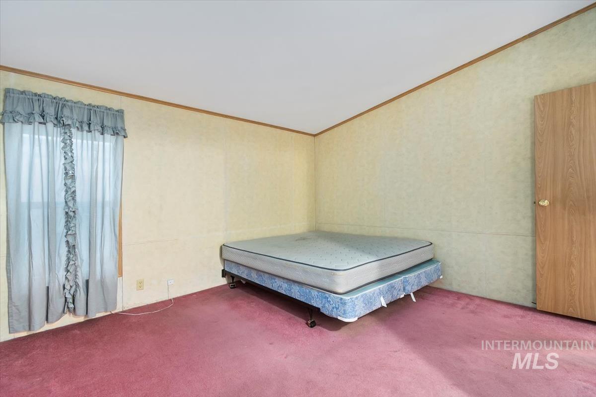 2804 Golden Rod Lane Caldwell, ID 83605 - Photo 6 of 35 Carpeted bedroom with ornamental molding