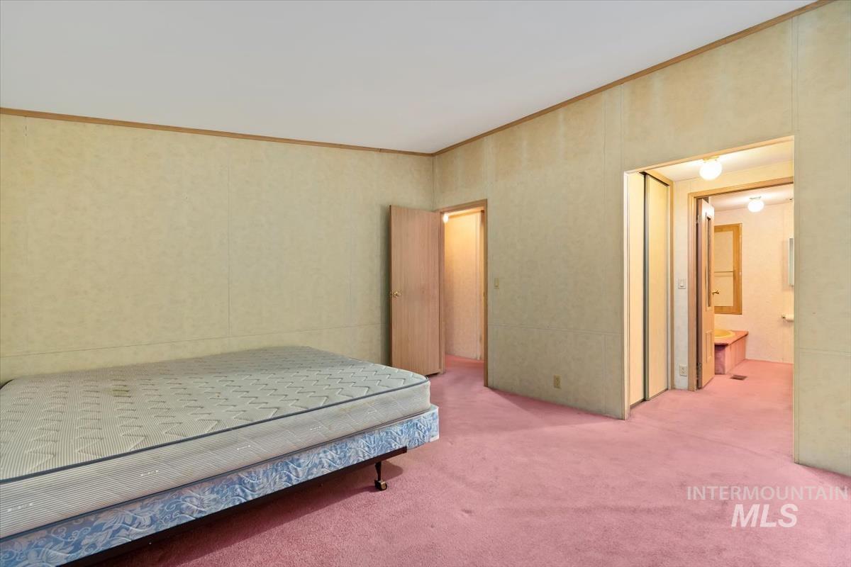 2804 Golden Rod Lane Caldwell, ID 83605 - Photo 7 of 35 Carpeted bedroom featuring crown molding and connected bathroom