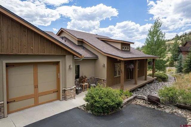 a view of a chairs and table in backyard of the house
