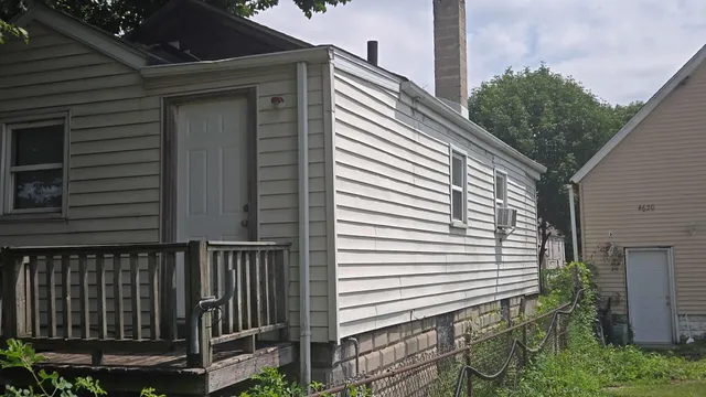 a view of a wooden balcony and trees