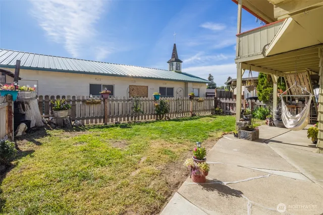 a view of a house with yard and a patio