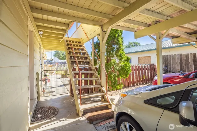 a view of a balcony and car parked