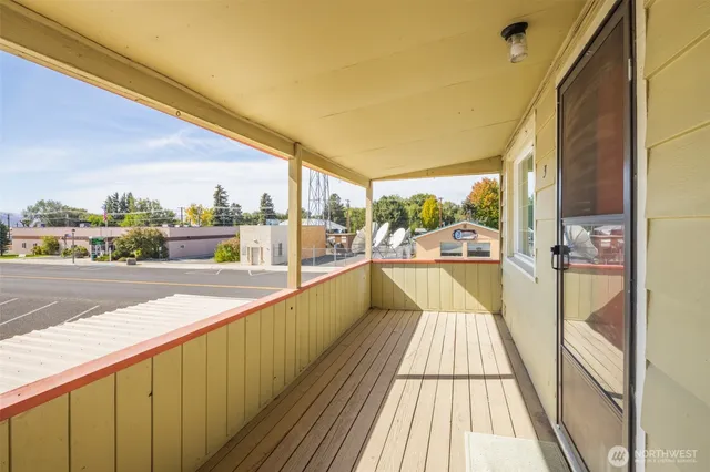 a view of balcony with wooden floor