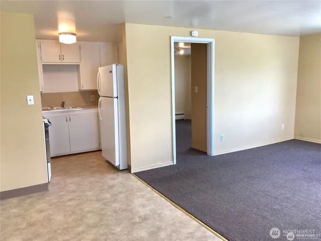 a view of a kitchen with refrigerator