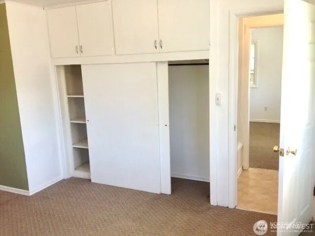 a view of an empty room with cabinet