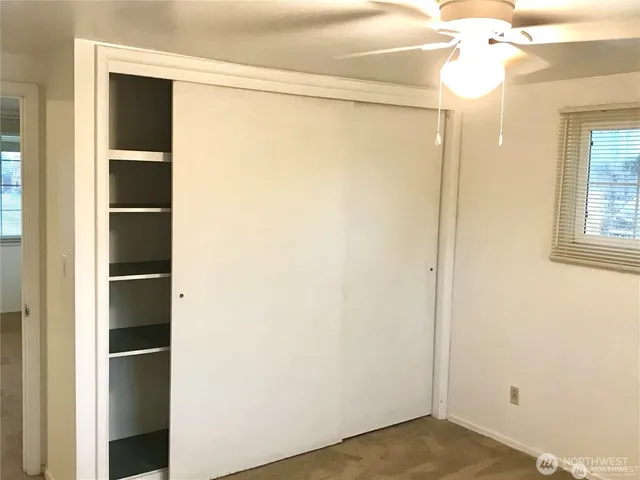 a view of closet with wooden floor